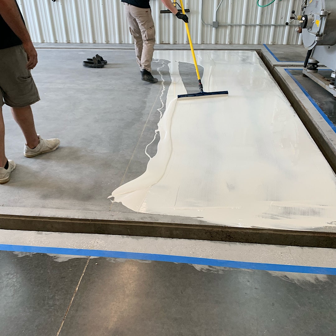 Installing white epoxy on our rug washing floor